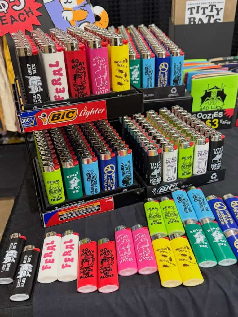 Colorful BIC lighters with illustrated designs arranged in trays on a retail merchandise table