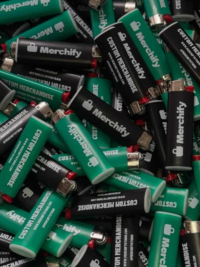 Green and black lighters with white Merchify logos and custom merchandise lettering