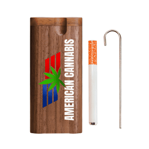 Wooden cannabis dugout with matching metal tool and cigarette.